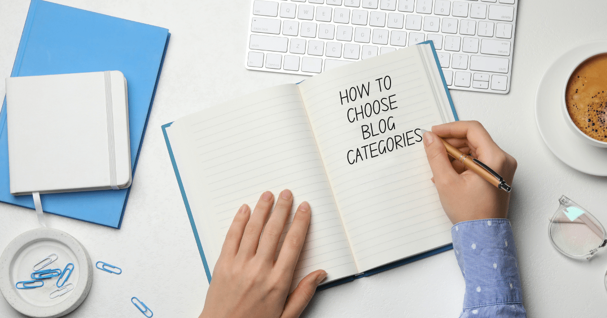 A person writing ‘How to Choose Blog Categories’ in a notebook at a tidy workspace
