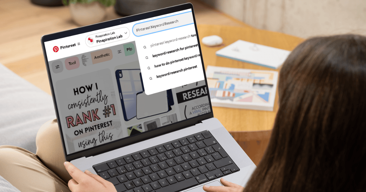 Woman working on a laptop researching Pinterest keywords